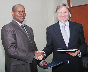 Minister of Finance James Musoni and Amb. Frans Makken shake hands after the signing. (Photo; J. Mbanda)