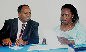 Executive Secretaries; Jean Baptiste Habyarimana and Domitilla Mukantaganzwa go through a document during the Press conference yesterday. (Photo/ J. Mbanda)
