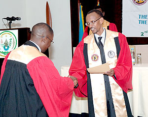 President Paul Kagame awarding one of the nine Surgeons that graduated during the COSECSA meeting yesterday. (Urugwiro Village photo)