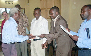 Dr. Emmanuel Nkurunziza hands over a certificate of attendance  to a local leader. (Photo: S. Rwembeho)
