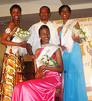 The Pageants pose for a photo with Minister Vincent Karega. Cynthia Akazuba (seated) and Annet Mahoro (right) have not received their prize money. (File Photo)