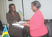 HERE YOU ARE:  Rosemary Museminali handing over to Louise Mushikiwabo