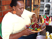 Joy Ndungutse, the Chief Executive Officer Gahaya Links sorts out earings that are ready for sale.
