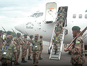 Members of the RDF disembarking the plane at the airport yesterday upon thier return from the EASBRIG joint military exercise in Djibouti. (Photo/ F.Goodman)