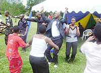 Bwishyura sector local leaders join other resident in a dance during an ocassion to mark 16 days of activis in Karongi district. (Photo: S. Nkurunziza)