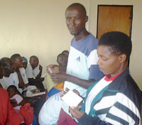 Two local leaders demonstrating how to use condoms. 