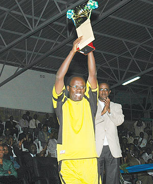 The Governor of Southern Province, Fidele Ndaysaba, lifts the trophy after his province won the Good Governance soccer tournament held at the end of the 7th National Dialogue. Looking on is the Senate president, Dr Vincent Biruta. 