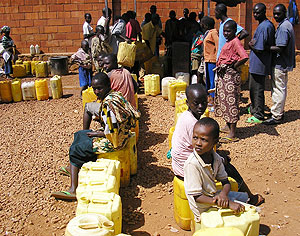 People queue to get water at one of the outlets in Kigali City. Kimihurura residents have resorted to using water from car washing bays as the crisis soars