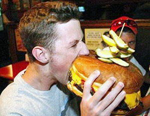 Eating a huge hamburger. Westerners donu2019t necessarily eat or live  better than Africans