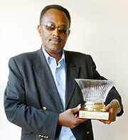 Dismas Kayibanda displaying the leadership appreciation trophy given to him by top rally driver Tony Seagerman on behalf of RAC members. (Photo: B. Mugabe).