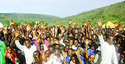 Residents of Rwagitima sector in Gatsibo district raise their hands up to say they will register for 2010 elections. (Photo: S. Rwembeho)