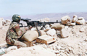 An undated handout picture obtained from the Yemeni army on November 27, 2009 shows a Yemeni soldier manning a machine gun at the battlefield in Saada province.