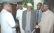 Cabinet Affairs Minister Protais Musoni  (L) greets members of the  Somali delegation who were accompanied by the Mufti of Rwanda Sheikh Saleh Habimana (R). (Photo/ J. Mbanda)