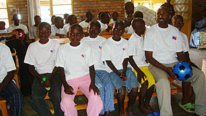 Guillaume Munyakabanza, the Ngoma Fina Bank branch accountant with some of the children of Karibu centre.