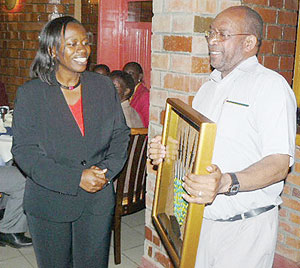 Vincent Sebahire receiving the best performing award from Monique Nsanzabaganwa minister of trade and industry