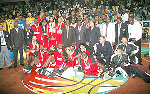 Sports Minister Joseph Habineza (standing centre), FIBA officials as well as players of the three top teams; Primeiro, Petro Atletico and APR enjoy a group photo after the closing ceremony. (Photo / F. Goodman)