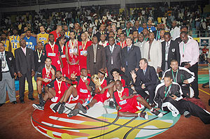 The three top teams Primeiro de Agosto, Petro Atletico and APR pose for a group with Sports minister Joseph Habineza (standing centre) and Fiba officials at the end of the ten-day championship in Kigali.