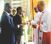 BLOOD OF JESUS: Archbishop Emmanuel Kolini administering Holy Communion to Health minister Dr. Richard Sezibera yesterday. (Photo/ E. Mutara)