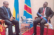 Ambassador Amandin Rugira (L) with President Joseph Kabila after the former presented his credentials. (Courtsey Photo)