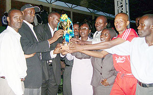 SWAA Rwanda officials hand over the trophy to Nyamabuye team. (Photo: D. Sabiiti)
