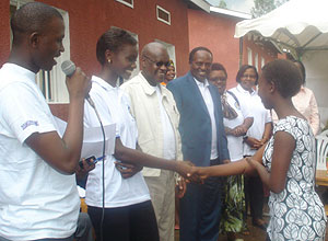 Miss Rwanda, Grace Bahati congragulates the best female student among the visited Nyanza orphans. 