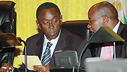 Premier Bernard Makuza consults Minister James Musoni during his appearance before parliament last week