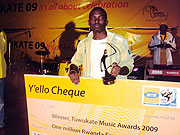 Iu2019ve made it! Tom Close poses with his prizes. (Photos by Aimu00e9 C. Nsengiyumva)