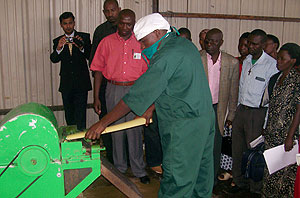 Trainees look on as a Utexrwa employee demonstrates how to use a machine to extract banana fibre. (Courtesy photo)