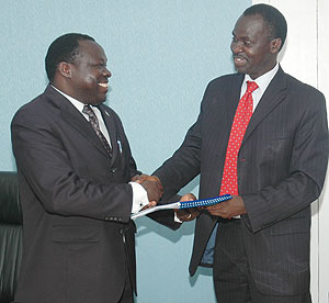 Minister Stanislas Kamanzi (Right) hands over to Christophe Bazivamo yesterday (Photo F Goodman)