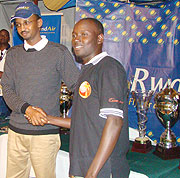 KGC President Marcel Byusa congratulates Emmanuel Ruterana after finishing third in the Rwanda Open pro category. Ruterana set a new course record this year.