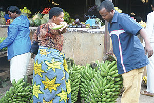 A man buys Bananas in Kimironko market. Restaurant owners around Kimironko have complained of the hiking of foodstuff prices at the market.