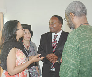 The Executive Secretary of the National Unity and Reconciliation commission Jean Baptiste Habyarimana (C) listens to some participants who attended the conference.