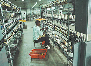 A UTEXRWA employee, working on a silk production line. (FIle Photo)