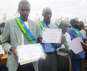 Gacaca judges display certificates of merit awarded to them. (Photo: C. Nyiramatama)