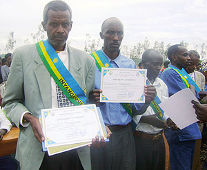 Gacaca judges display certificates of merit awarded to them. (Photo: C. Nyiramatama)