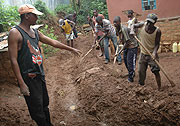 Residents of Rugarama village in Kinyinya sector of Gasabo District dig trenches yesterday to divert rain water from their houses. (Photo/ J. Mbanda)