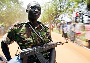 A Sudan Peopleu2019s Liberation Movement (SPLM) soldier keeps watch from the back of a car in Juba, southern Sudan