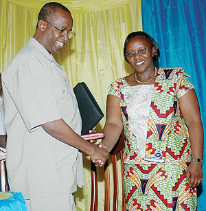 Protais Rumanzi from the National Electoral Commission (L) congratulates the Mayor-elect of Nyarugenge District, Theophila Nyirahonora, after her election. (Photo J Mbanda)