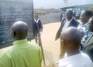 NURC boss, Jean Baptiste Habyarimana being shown the achievements made by genocide convicts with help of residents. (Photo: D. Sabiiti)