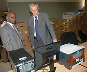 National Institute of Statistics of Rwanda Director General Yusuf Murangwa (L) receiving the donation from UNFPAu2019s Ian Howie yesterday. (Photo/ J. Mbanda).