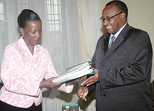Foreign Affairs Minister Louise Mushikiwabo (L) hands over ministry documents to the Minister of Cabinet Affairs yesterday. (Photo/ J. Mbanda)