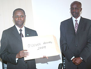 State Minister for Primary and Secondary Education, Mathias Harebamungu (L), displays 2009 Ou2019Level results as RNECu2019s John Rutayisire looks on yesterday. (Photo/ J. Mbanda)