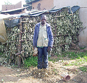 One of the poor beneficiaries Paul Nsabimana stands before the shed he constructed for the cow he was directed to return to the original owner. (Photo: A. Gahene)