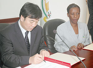 Chinese Vice Minister of Foreign Affairs  in Charge of Africa, Zhai Jun ,(L) and Rwandau2019s Louise Mushikiwabo during the signing ceremony Yesterday. (Photo J Mbanda)