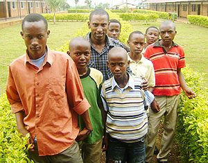 Headmaster  John Africa (centre) poses for a photo with some of his pupils who execelled in PLE. (Photo: S. Rwembeho)