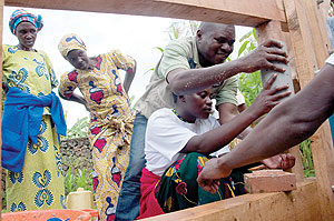 Jean Bosco Bichamakara, the head of ICCNu2019s Energy Production Program, trains a group of 20 residents how to make briquettes.