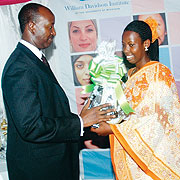 The first best performer Ernestine Musengerwa receives a gift from the Permanent secretary of the Ministry of Commerce and Industry Antoine Ruvebana. (Photo: J Mbanda)