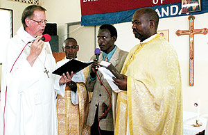 Bishop Denis Mugabo (R) being ordained.