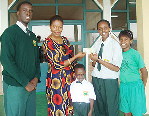 Green Hills Academy students present a cheque to Didi Farmer- a Haitian national,  to assist the Haiti earthquake victims.(Photo/ I. Niyonshuti)