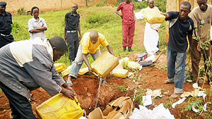 Kabarondo Police pouring Kanyanga that was recently impounded from traffickers. (File photo)